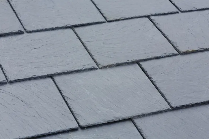 Closeup of traditional grey slate roof tiles on a pitched roof