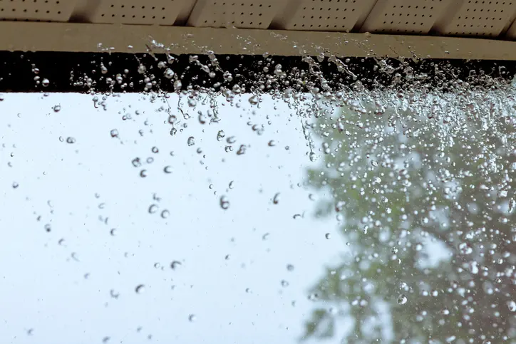 When it rains heavily, water pours out of over gutters.